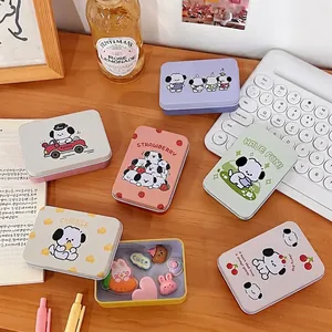 Cute cartoon dog tin storage box set for jewelry and stickers on a minimalist desktop