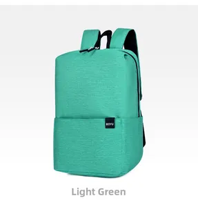 Detail view of a light green minimalist backpack with oxford fabric and side brand label