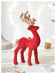 Detail of red flocked reindeer ornament with golden glitter antlers for Christmas decor