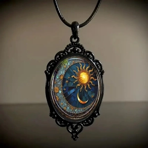 Close-up of gothic crow cross necklace with sun and moon mosaic pattern on black metal