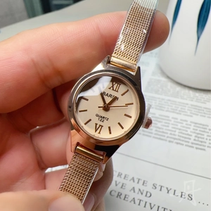 Elegant rose gold mesh strap watch for women with a champagne dial and roman numerals