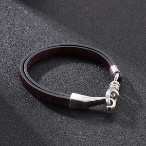 Detail of brown litchi pattern leather strap and brushed stainless steel hook clasp