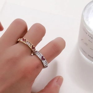 Luxe copper open rings with red heart stones and clear zircon worn by a model