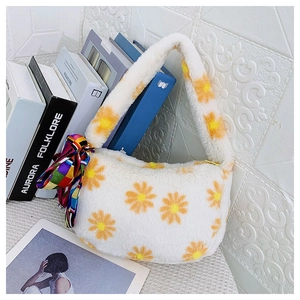 Detail of white plush handbag with yellow daisy patterns and colorful silk scarf