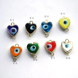 Detailed view of eight heart-shaped evil eye enamel pendants with gold metal borders