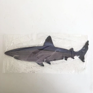 Detail shot of a shark steel art wall decoration packaged in a clear protective plastic bag