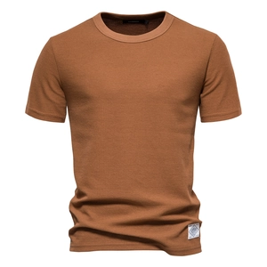 Macro detail of brown waffle knit texture and premium stitching on short sleeve T-shirt