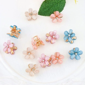 Mini floral hair claws with frosted acrylic petals and rhinestones in pastel colors