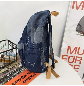Side view of denim patchwork backpack with adjustable khaki straps and side pockets