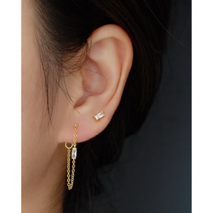 Elegant gold zircon earrings featuring rectangle stud and chain tassel on model