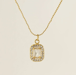 Macro shot of gold square emerald-cut zircon pendant on a fine double layer S-chain