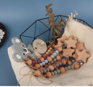 Close-up of a koala silicone teether with colorful beads in a modern wire basket