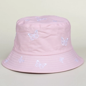 Detailed close-up of white butterfly embroidery on a soft pink cotton bucket hat