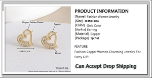 Detailed view of heart-shaped gold-plated copper earrings with sparkling zircon inlay