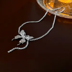 Silver butterfly pendant necklace with crystal tennis chain on a luxury leather surface