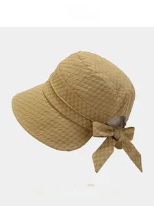 Detail of 3D bubble texture and bow ornament on a khaki sun hat for women