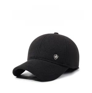 Close-up of black winter baseball cap featuring fashion metal shield logo and ear protection