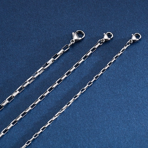 Polished stainless steel box chain bracelets in three varying widths on blue fabric