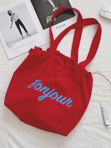 Large red nylon tote bag with blue bonjour lettering and drawstring for summer travel