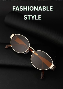 Macro view of retro oval sunglasses with golden metal frame and brown UV lenses
