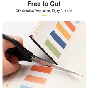 DIY colorful rectangular block patterned floor mat being cut with scissors for custom fit
