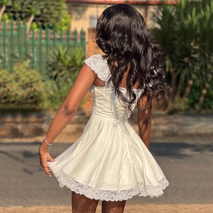 Elegant white lace mini dress with sexy backless lace-up detail for outdoor street style