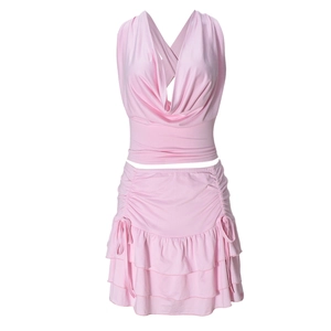 Detail of pink cowl neck halter crop top and ruffled tiered mini skirt two-piece set