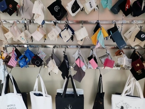 Collection of various fabric drawstring bags and canvas totes in multiple sizes and colors