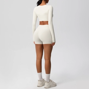 Back view of ivory brushed long-sleeve yoga set with high waist shorts on a model