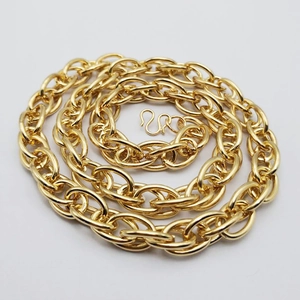 Close-up of golden twist rope chain necklace detail with polished metallic finish