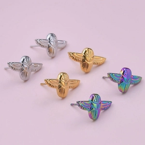 Detailed macro view of 304 stainless steel winged beetle studs in gold and silver finishes
