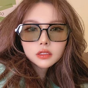 Detail of retro square oversized sunglasses with black double-bridge frame on model