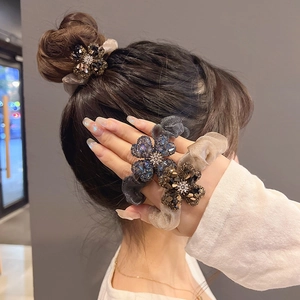 Sparkling rhinestone clover scrunchies set in blue, coffee, and champagne gold tones