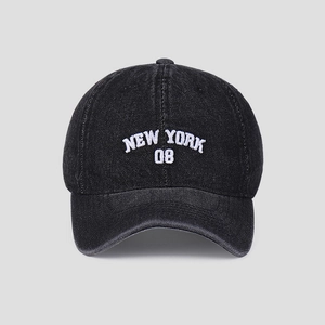 Detail view of white 3D NEW YORK 08 embroidery on washed black denim baseball cap
