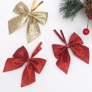 Glittering red and gold Christmas bows for tree ornaments and festive gift decoration