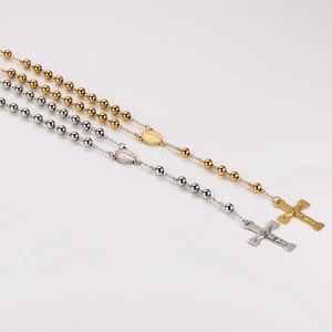 Gold and silver stainless steel rosary necklaces with cross pendants on white background