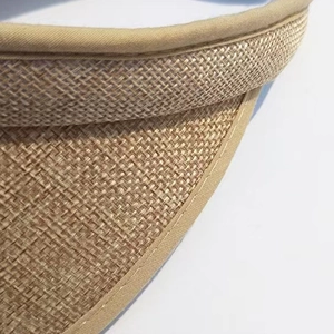Close-up of the woven straw texture and fine edge stitching on this beige sun visor