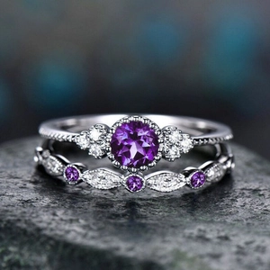 Two-piece silver halo ring set with round purple gemstone and curved band details