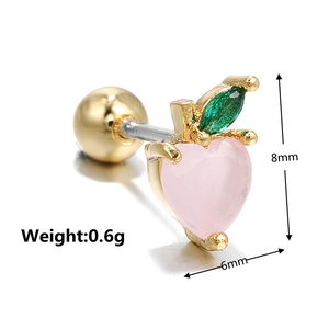 Macro detail of peach shape earring with pink crystal and green leaf gems