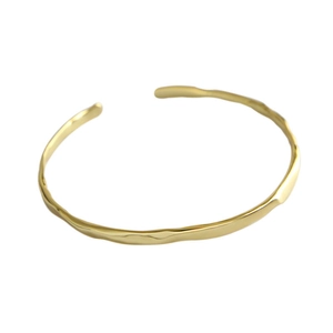 Modern 925 sterling silver cuff bracelet with irregular wavy texture and gold polished finish