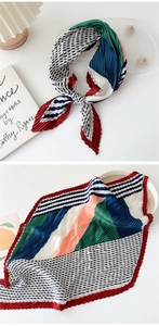 Detail of pleated geometric scarf showing both tied style and texture on white desk