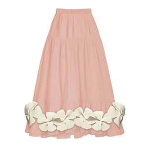 Detail of light pink tiered maxi skirt featuring white floral petal hem decorations