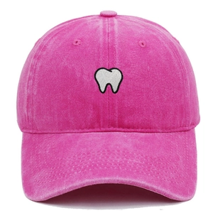 Detailed close-up of white tooth embroidery on a rose pink washed cotton baseball cap