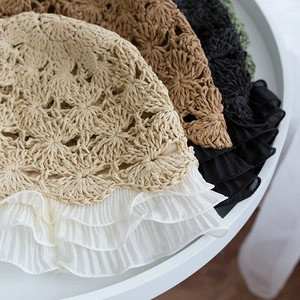 Close-up of woven sun hats with chiffon pleated lace edges in beige, brown, and black
