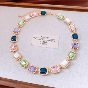 Detailed macro shot of vintage French style necklace with multicolored square gemstones