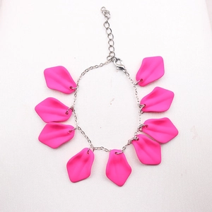 Bohemian style bracelet featuring pink petal charms and silver metal chain link design
