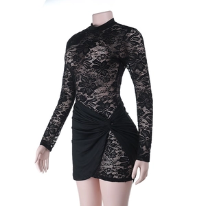 Detailed close-up of intricate black floral lace pattern and gathered hem of the mini dress
