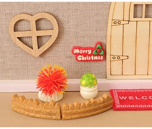 Miniature Christmas set with wooden heart window, red Merry Christmas sign, and fences