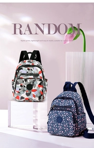 Detail view of stylish nylon backpacks with floral patterns and multiple zipper pockets