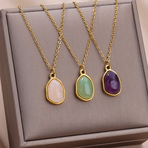 Detailed view of teardrop pendants in pink, green, and purple with 18K gold-plated chains